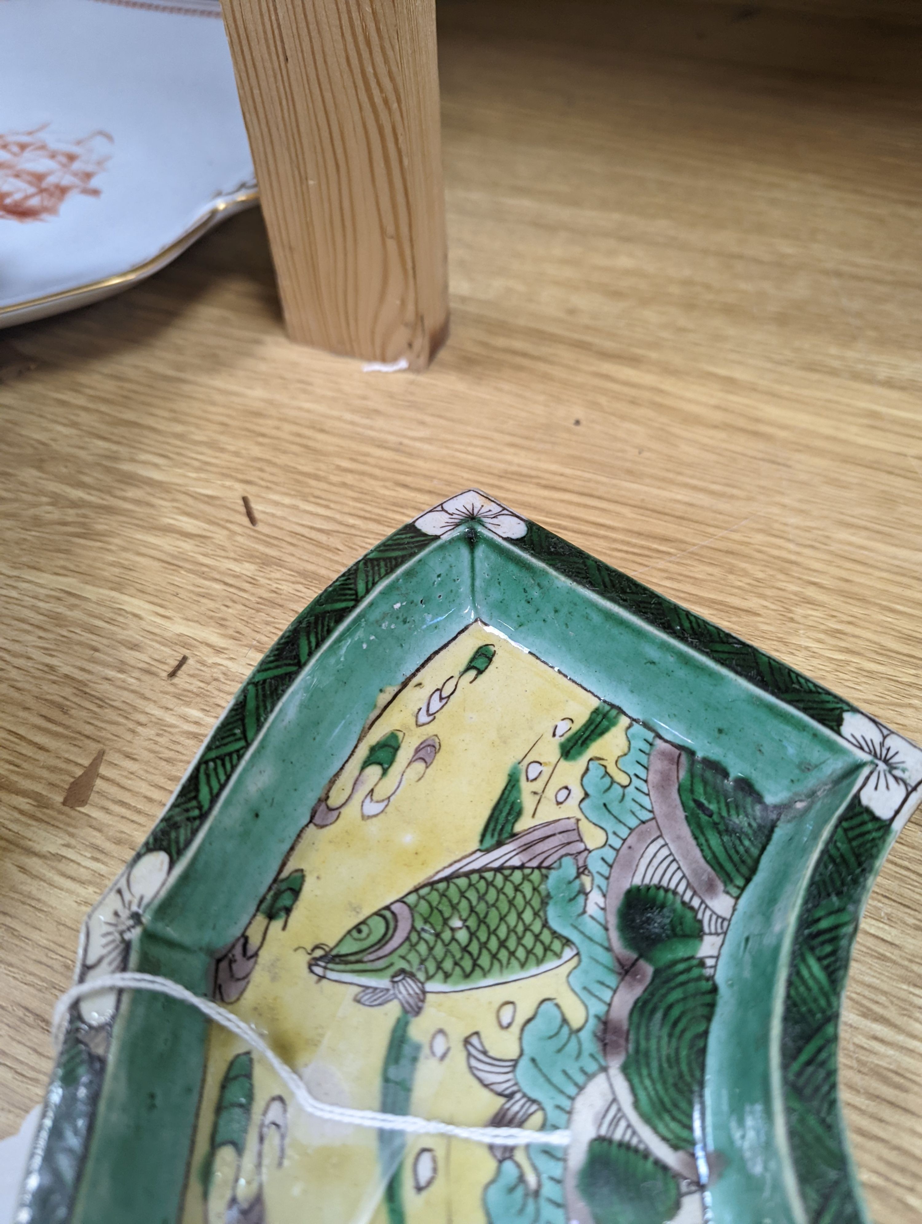 A pair of Chinese famille verte biscuit fan-shaped sweetmeat dishes, Kangxi, 20 cms wide.
